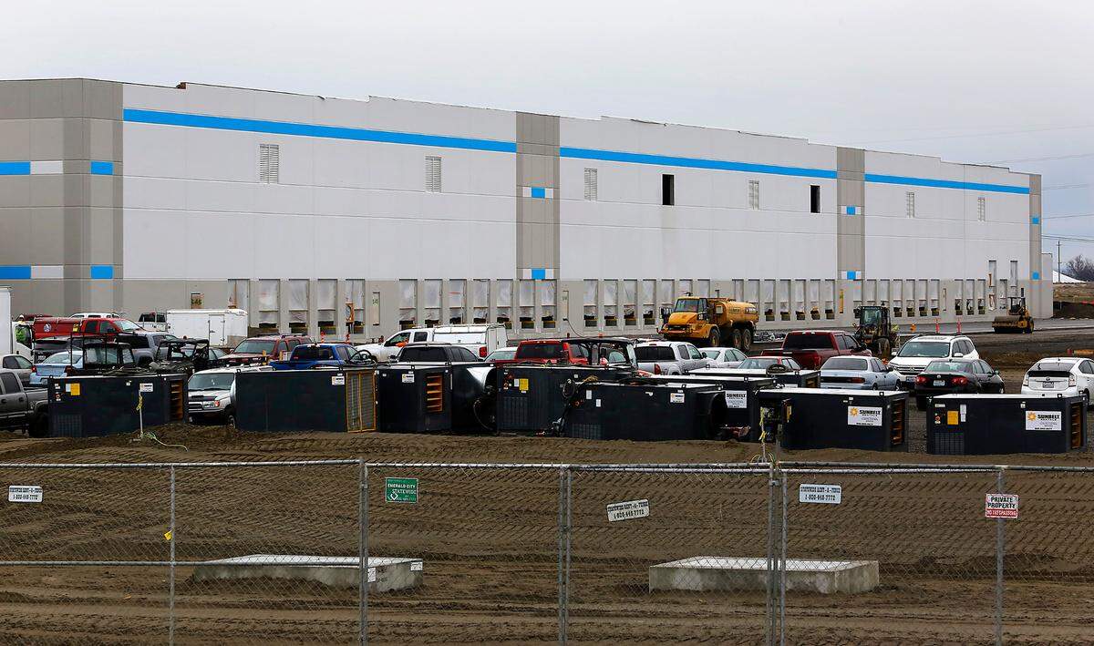 As work on the exterior of the two Amazon warehouses nears completion in east Pasco, contractors have begun to apply for permits to begin work on some interior systems.