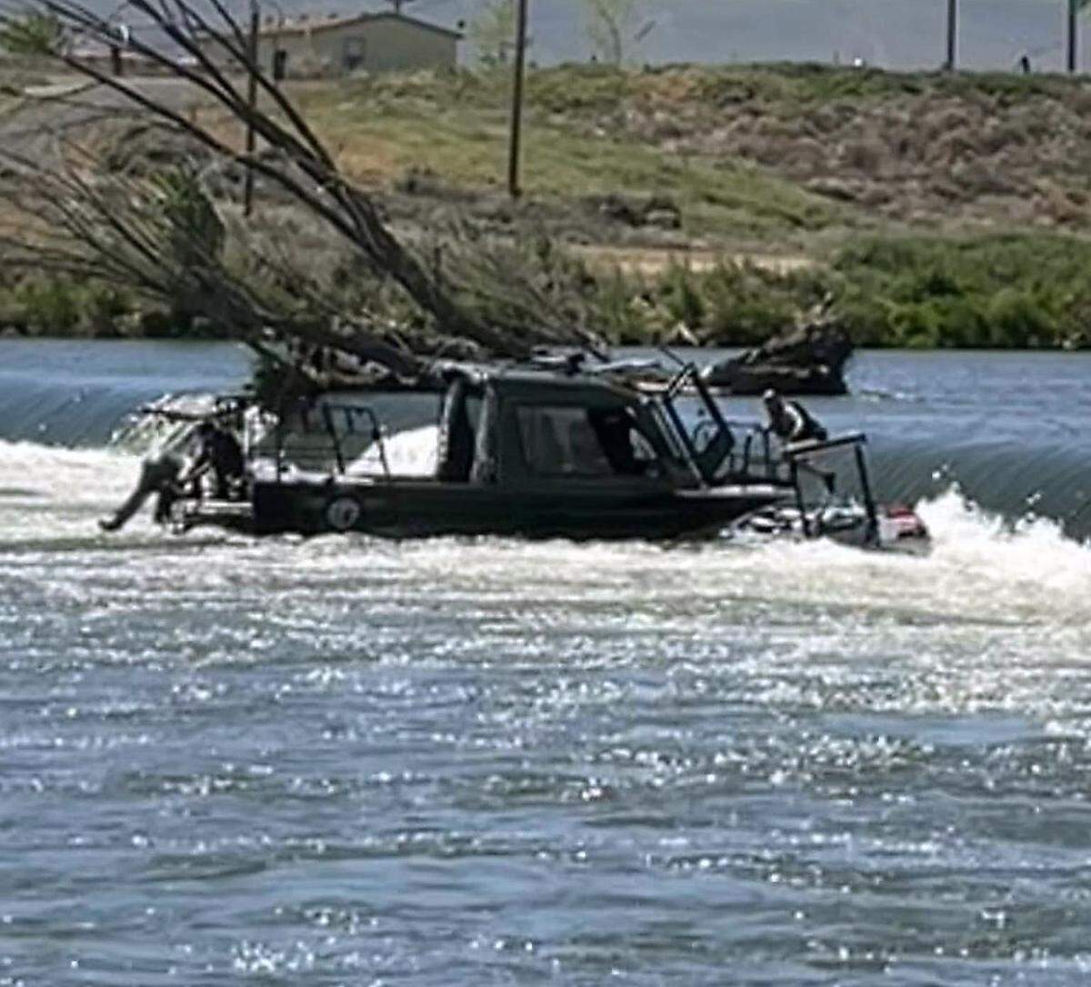 The Benton County Sheriff’s Office uses its jet boat on the Yakima River at Wanawish Dam to assist in the rescue of a firefighter who became stranded on a fire rescue boat.