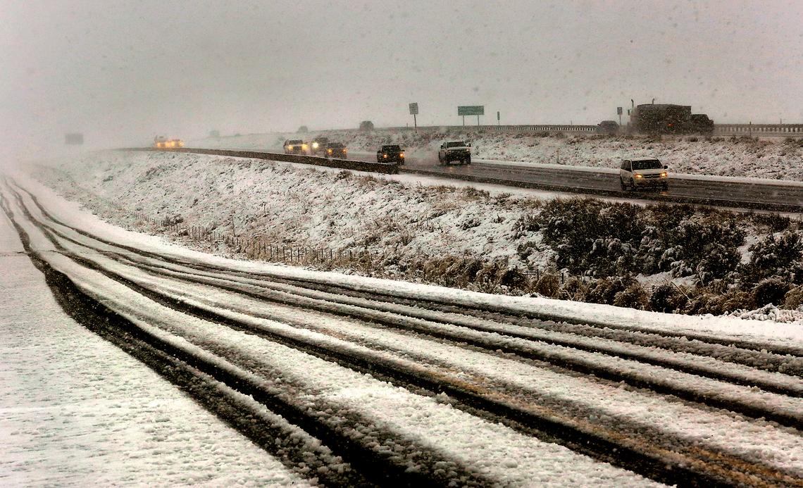 A wet heavy snow covers Bofer Canyon Road near Bateman Road just south of Kennewick as traffic on Interstate 82 travels through a spring snow storm that has blanketed many areas around the Mid-Columbia.