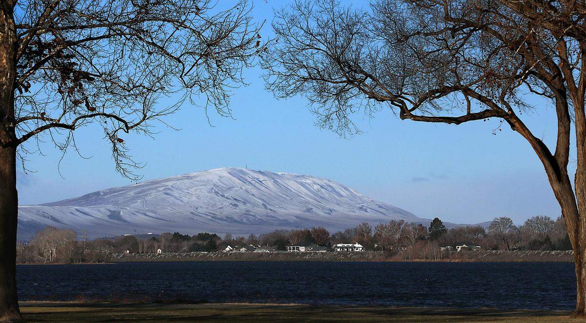 Clear skies and brilliant sunshine highlights snow-capped Rattlesnake Mountain the day following a surprise overnight winter snowfall that blanketed much of the Mid-Columbia region.