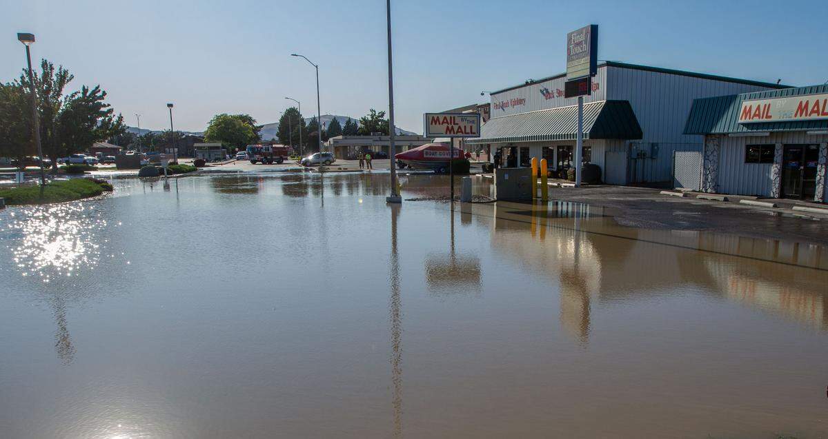 A small lake formed outside of Mail by the Mall, Final Touch Upholstery and Back Street Hair Design after a 10-inch water main broke at the Gage Boulevard and Center Parkway intersection in Kennewick around 4 p.m.
