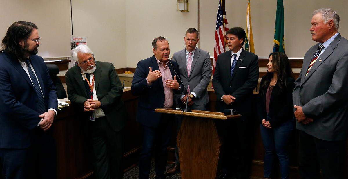 State and county leaders representing Franklin and Benton Counties share the podium and microphone Friday morning at the Franklin County Courthouse for a news conference to discuss the broken public defense system in Washington state. From left: Franklin Deputy Prosecutor Daniel Stovern, Larry Ziegler Franklin County Office of Public Defense Manager, Sen. Matt Boehnke R-Kennewick, Benton Prosecutor Eric Eisinger, Benton County Commissioner Mike Alvarez, Sen. Nikki Torres R-Pasco and Franklin County Commissioner Clint Didier.