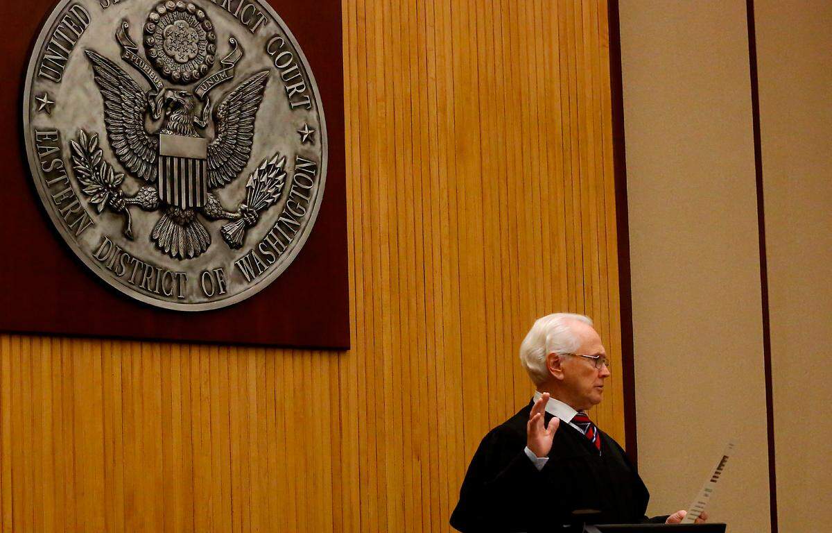 U.S. District Court Senior Judge Edward F. Shea conducts the citizenship swearing ceremony for 24 local immigrants from nine different countries at the Federal Building in Richland.