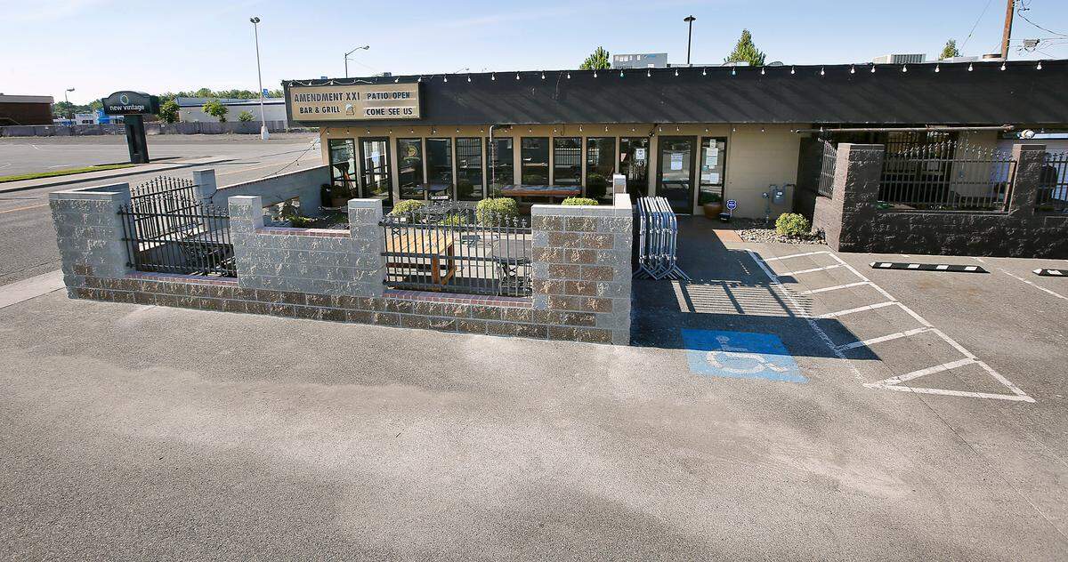 The Amendment XXI Bar & Grill on North Columbia Center Boulevard in Richland recently expanded its outdoor patio seating by building concrete block walls in the parking lot.
