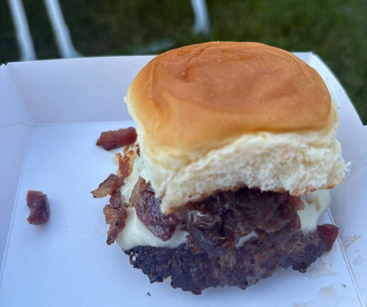 The Holy Aioli burger is a Dog Haus specialty. You can get it as a full burger for $14.50, and make that a combo with chips and a drink for an additional $2.50. Or you can get a slider for $4, or the two-slider meal with chips and a drink for $10.