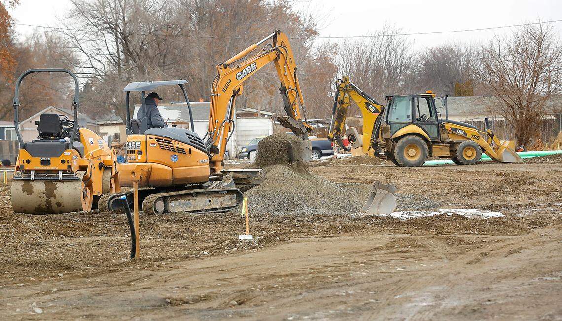 Construction workers operate excavating equipment at the site of a new project by the Kennewick Housing Authority for micro home units to house homeless families with children, homeless veterans and homeless people with disabilities.