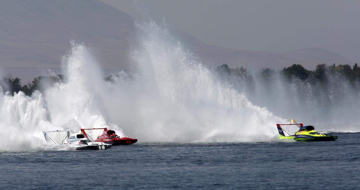 Driver Corey Peabody, left, in the U-9 Miss Beacon Plumbing unlimited hydroplane outruns his teammate J. Michael Kelly in the Miss Beacon Electric and Jamie Nilsen in the U-11 Miss Legend Yacht Transport presents The Truss Company to claim the checker flag in Heat 3A of the Columbia Cup race.