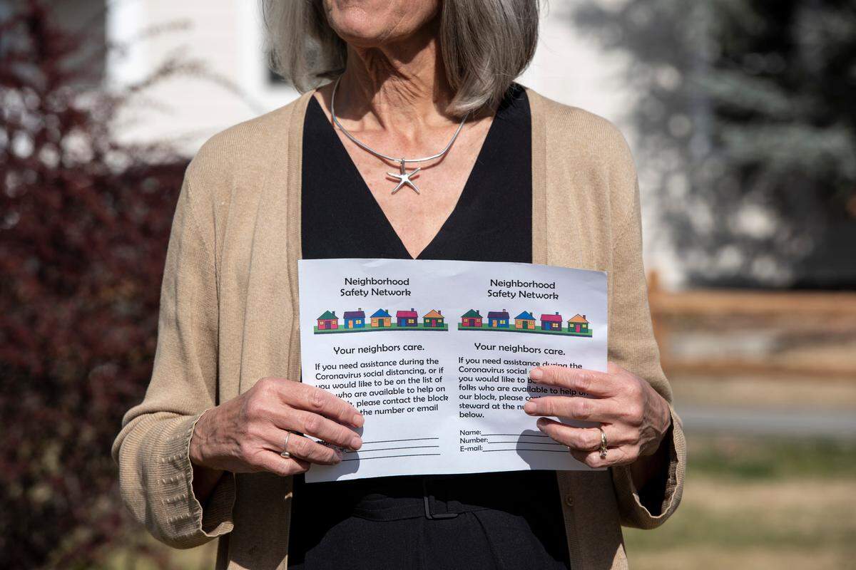 Pat Holten holds a flier for the Richland neighborhood safety network that she and others are using to connect with each another during the coronavirus outbreak and social distancing initiatives.