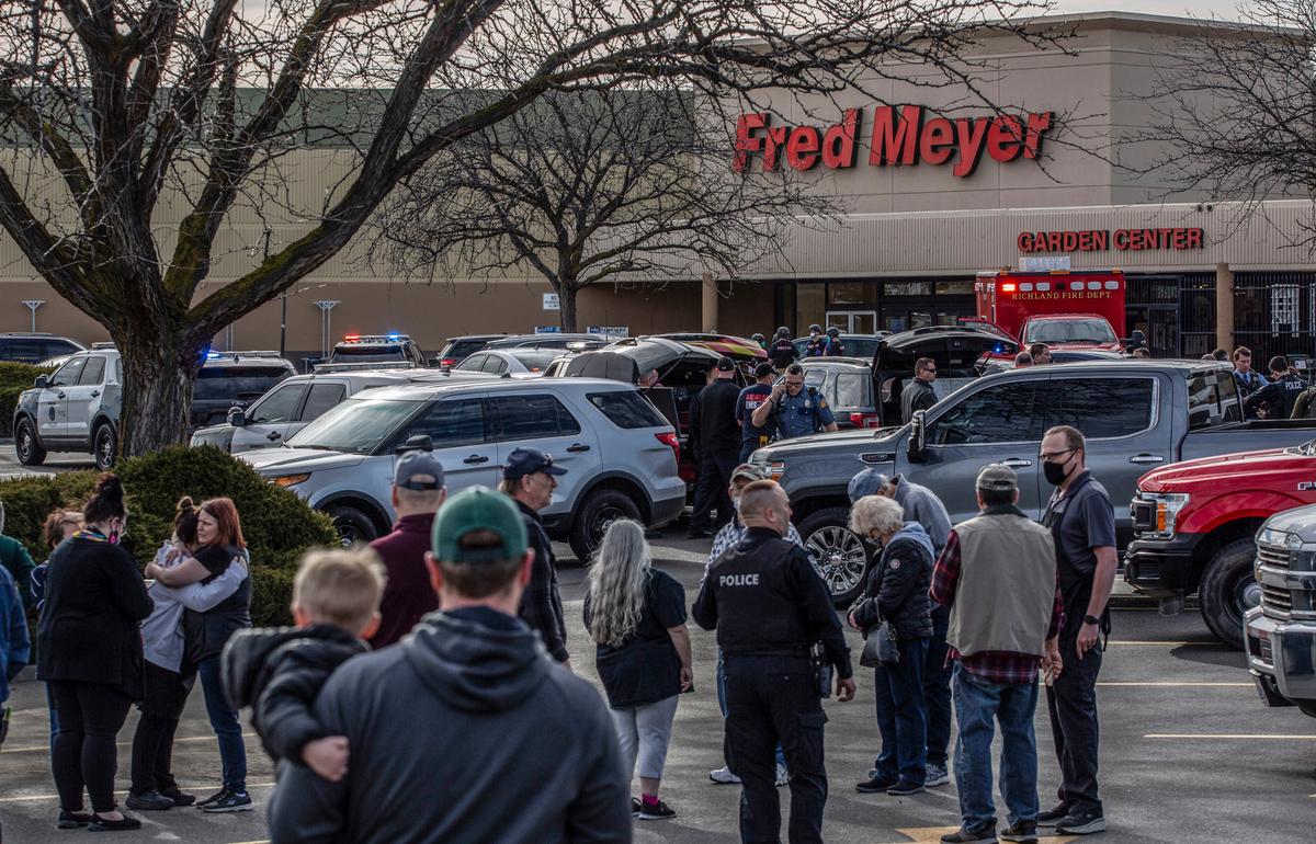 Tri-Cities law enforcement officers talk with employees and customers who witnessed the February, 2022 shooting at the Fred Meyer in Richland, WA.