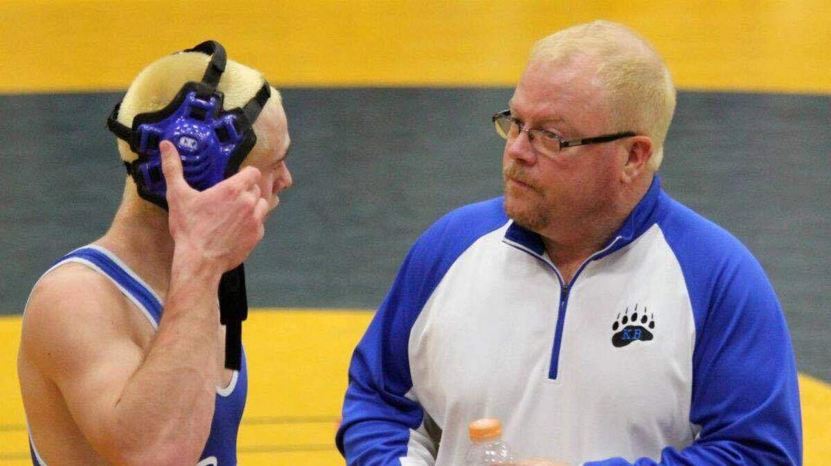 Kiona-Benton High School wrestler Kale Setzer, right, talks to coach Ben Hill after a match. Hill died Monday.