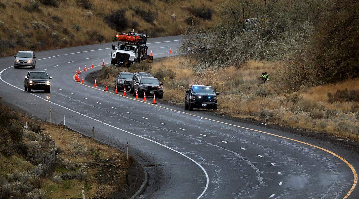 Investigators from the Washington State Patrol document the scene were a person was found dead Wednesday morning in the median of eastbound Highway 240 to Interstate 182 in Richland.