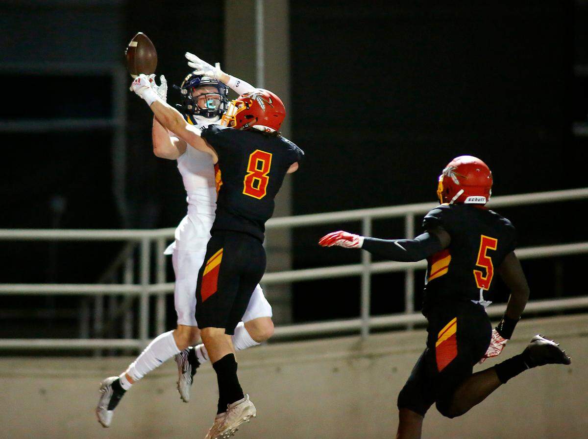 Kamiakin defender Kyler Bacon (8) breaks up a pass near the end zone intended for Kamiakin’s Brendan Beckwith as his teammate Tuna Altahir also pursues the play during Friday night’s game at Lampson Stadium