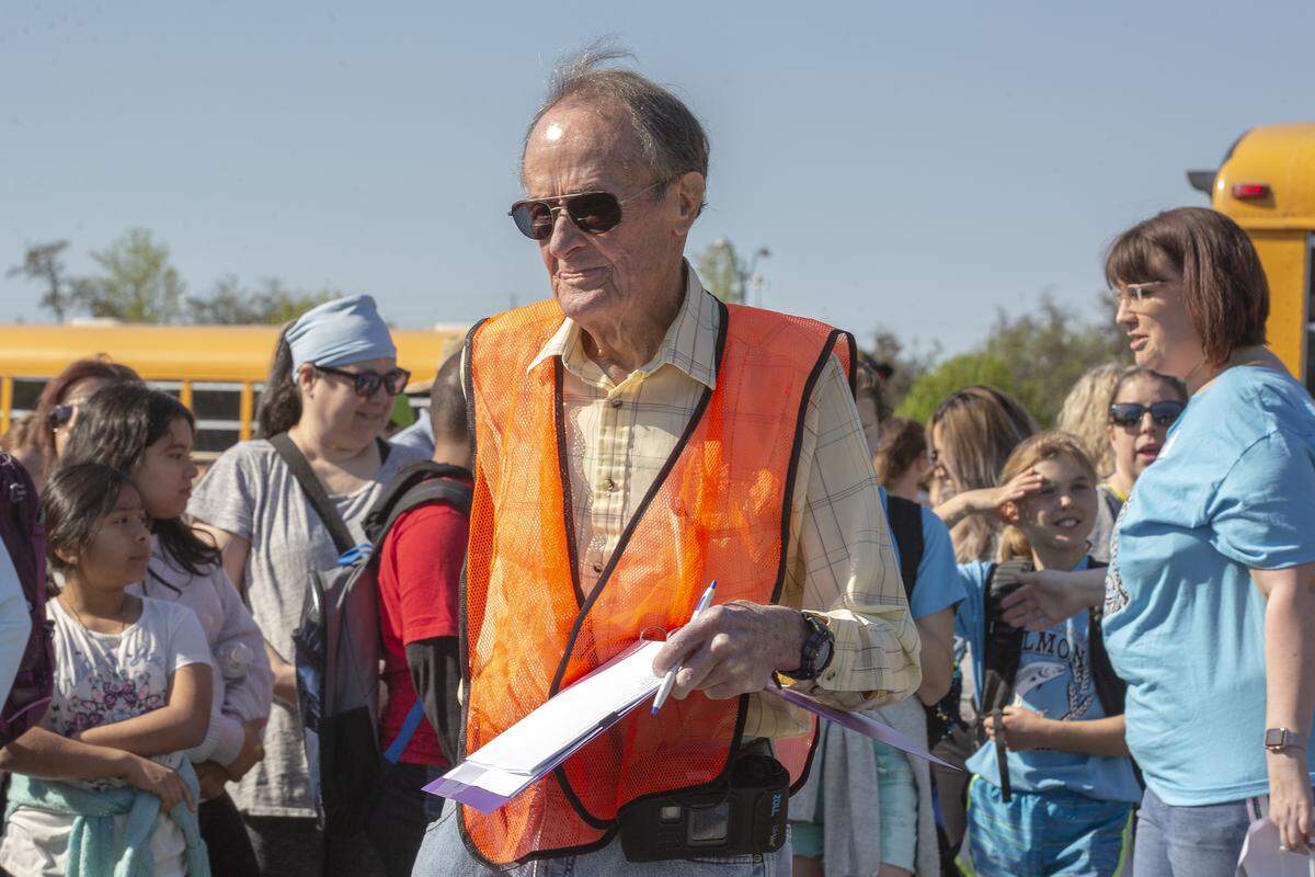 Gene Van Liew walks groups of students and their teachers back to where they will release the salmon at Columbia Park in Kennewick. Van Liew started volunteering in 2003.