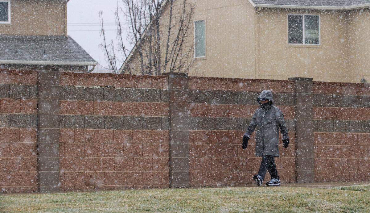 A walker braves the snowy weather for a stroll along W. 19th Ave. in Kennewick on Thursday morning. More snow is forecasted for Sunday.