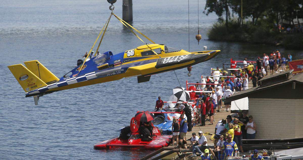Unlimited hydroplane racing teams line the pit docks in preparation for a race during the Tri-Cities Water Follies annual summer event along the Columbia River in Kennewick’s Columbia Park.