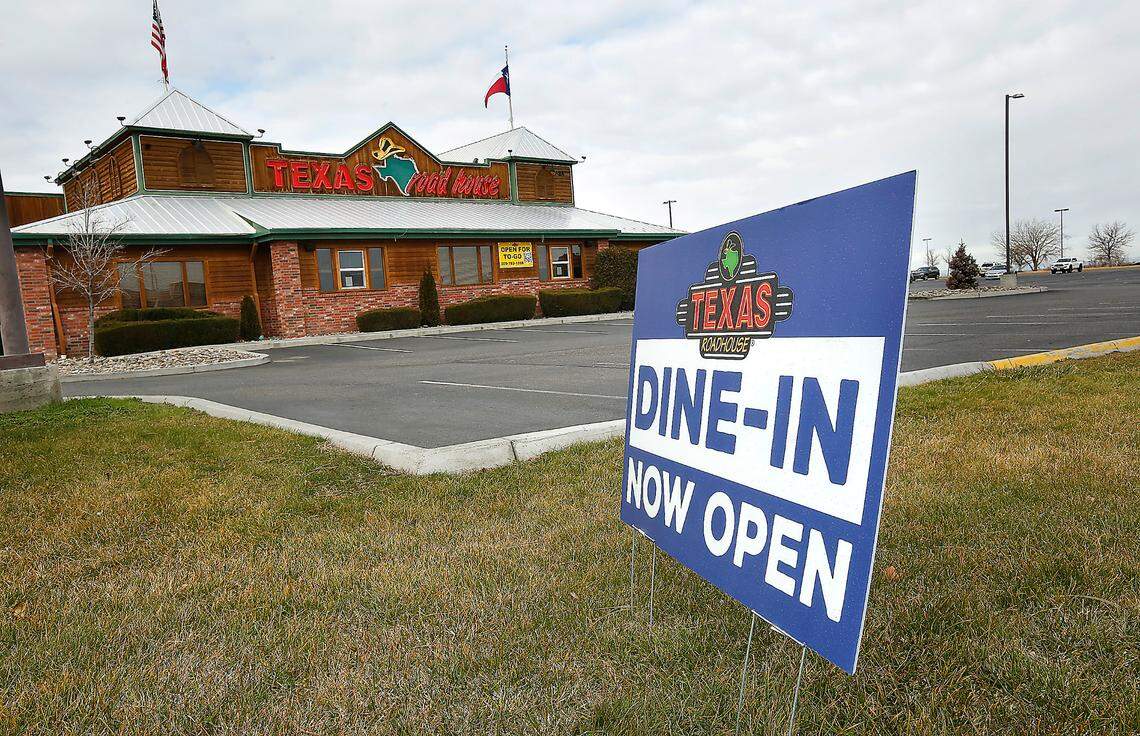 A sign on display in front of the Texas Roadhouse restaurant on Columbia Center Boulevard in Kennewick advertises for indoor dining.