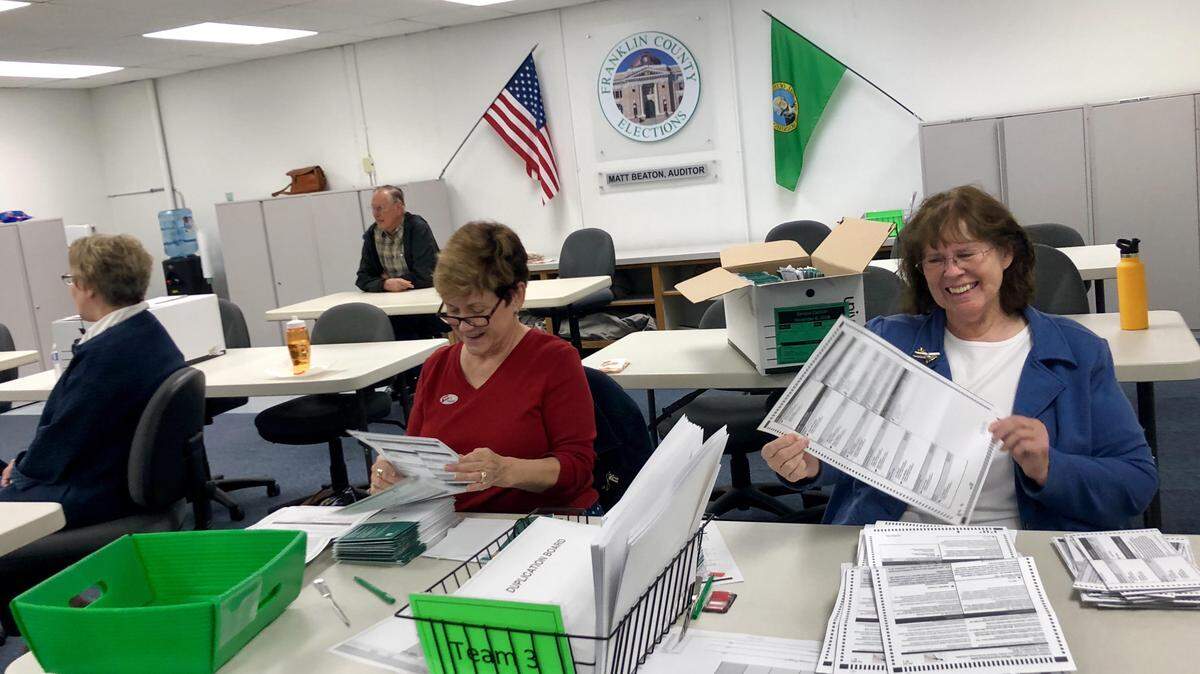 Election workers Nancy Ballard, left and Marjy Leggett inspect ballots in the Franklin County Courthouse in Pasco on Nov. 6.