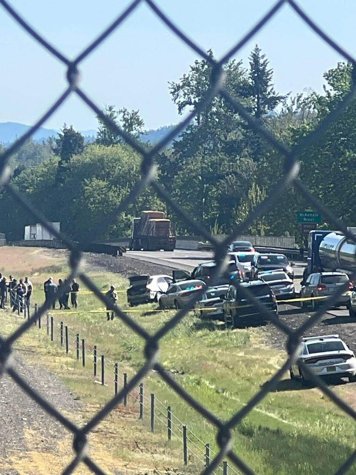 A KEZI 9 News crew films the aftermath of a high speed chase near Eugene, Ore. involving suspected West Richland killer Elias Huizar.