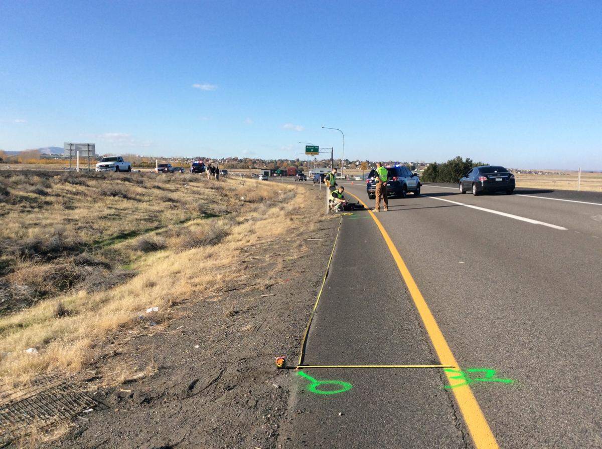 Investigators take measurements on Nov. 4, 2018, after the body of Martin Perez Garcia was found in the median off Highway 395 near Argent Road.