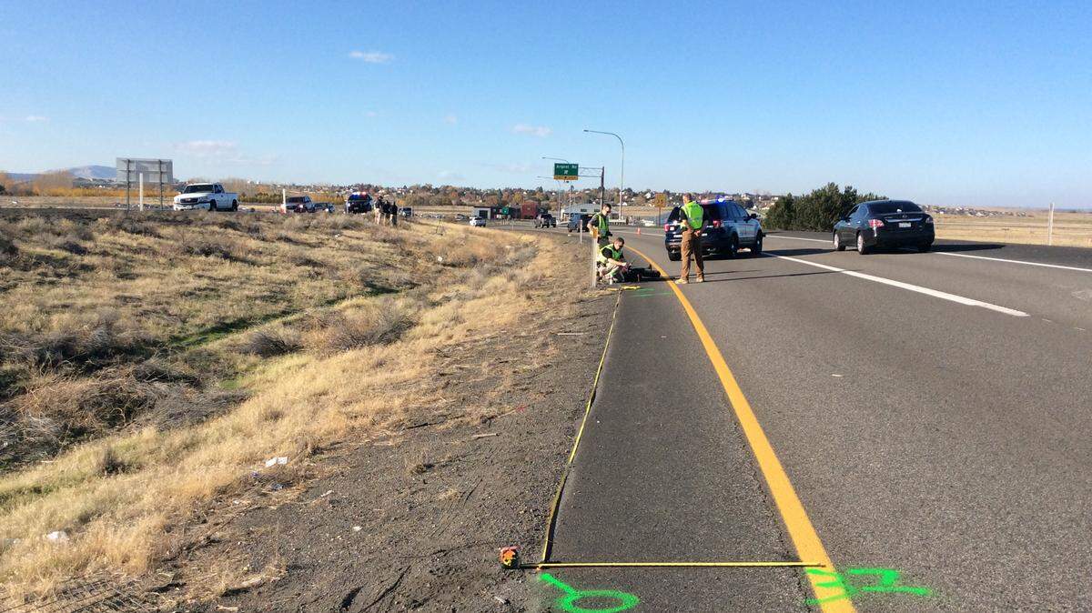 Washington State Patrol and Pasco police take measurements Sunday afternoon after a body was found in the median off the northbound ramp off Highway 395 near Argent Road.