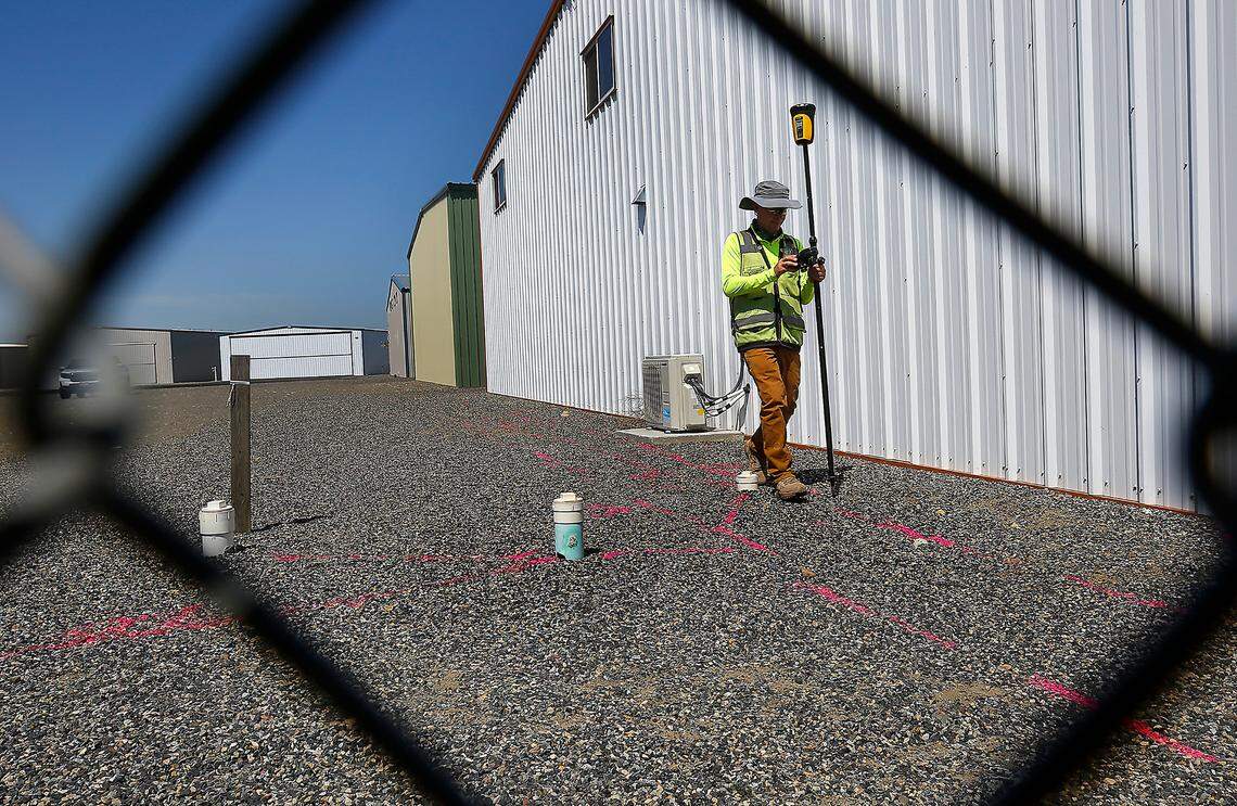 Mark Villa, of Geophysical Survey in Kennewick, maps out underground lines he marked with paint by using ground penetrating radar inside the fenced hangar area at the Port of Benton’s Richland Airport.