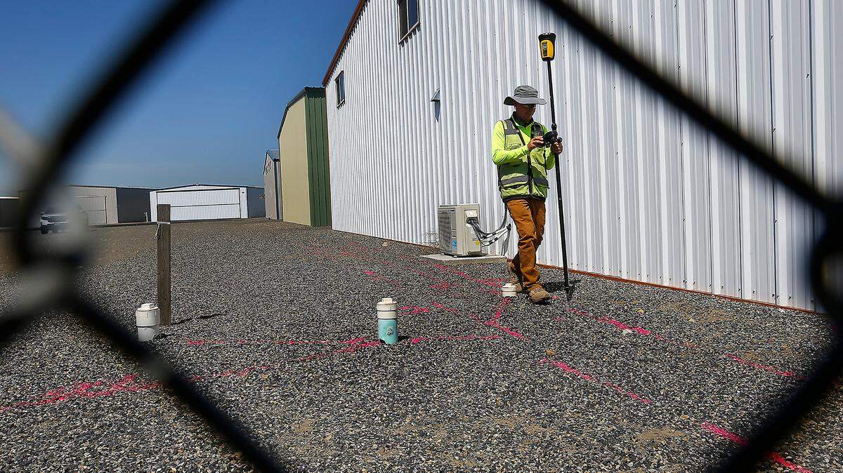 Mark Villa, of Geophysical Survey in Kennewick, maps out underground lines he marked with paint by using ground penetrating radar inside the fenced hangar area at the Port of Benton’s Richland Airport.