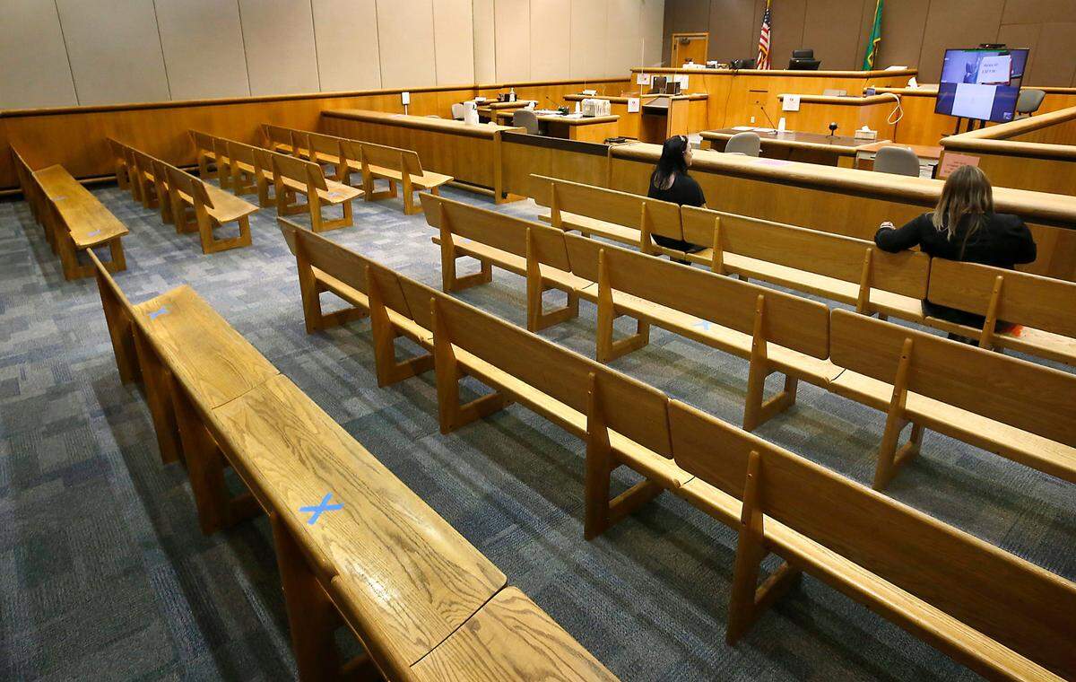 Blue tape X’s mark spots on benches in a Benton County Superior courtroom where public seating is available to maintain proper social distancing guidelines during the coronavirus pandemic.