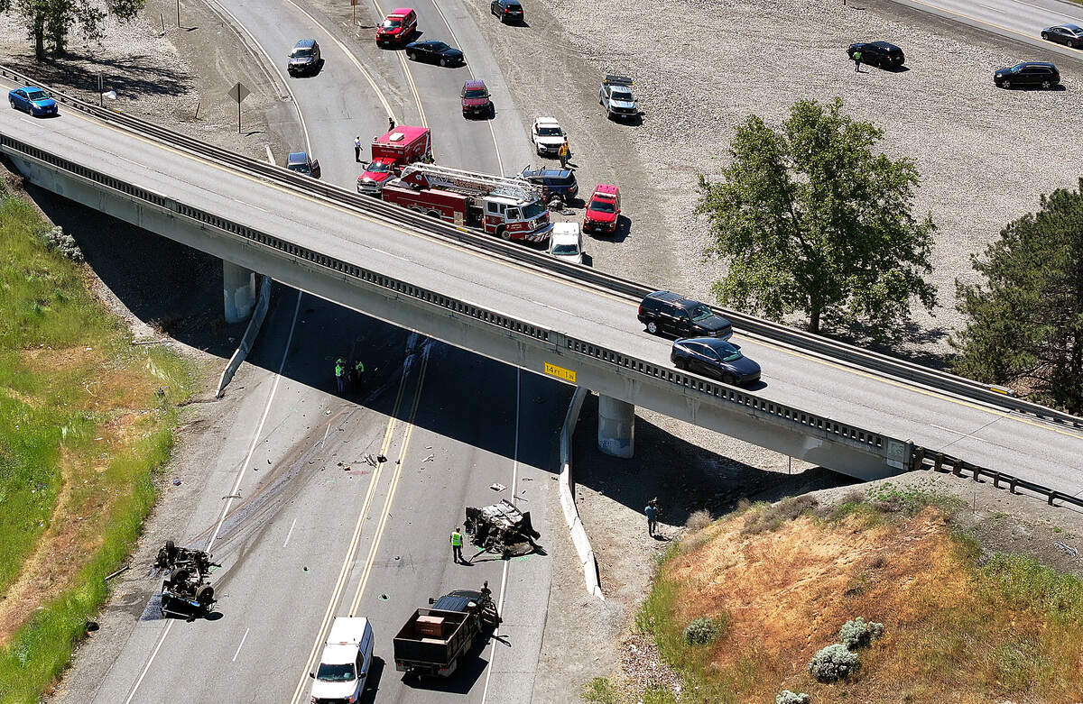 Washington State Patrol troopers investigate the scene of Thursday's double fatal collision at the Lewis Street exit on Highway 395.
