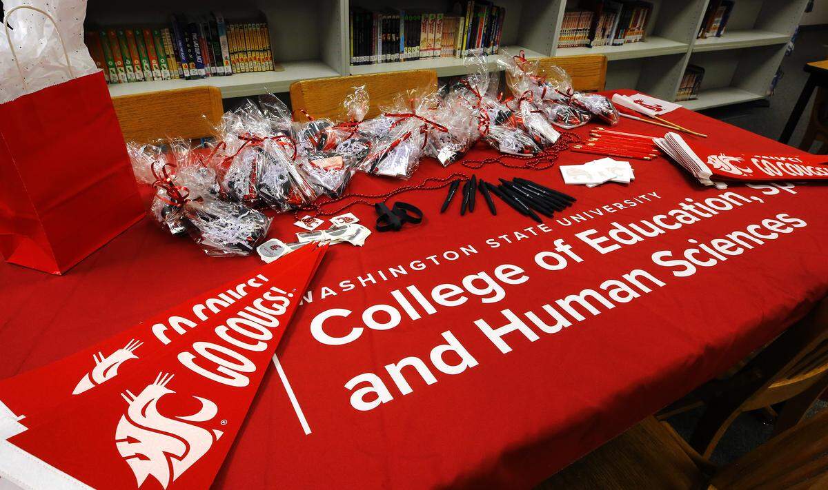 Cougar swag items cover a table in the Park Middle School library during a Thursday monring ceremony designating the Kennewick school a WSU Tri-Cities College of Education, Sport and Human Services Teaching Laboratory School. 