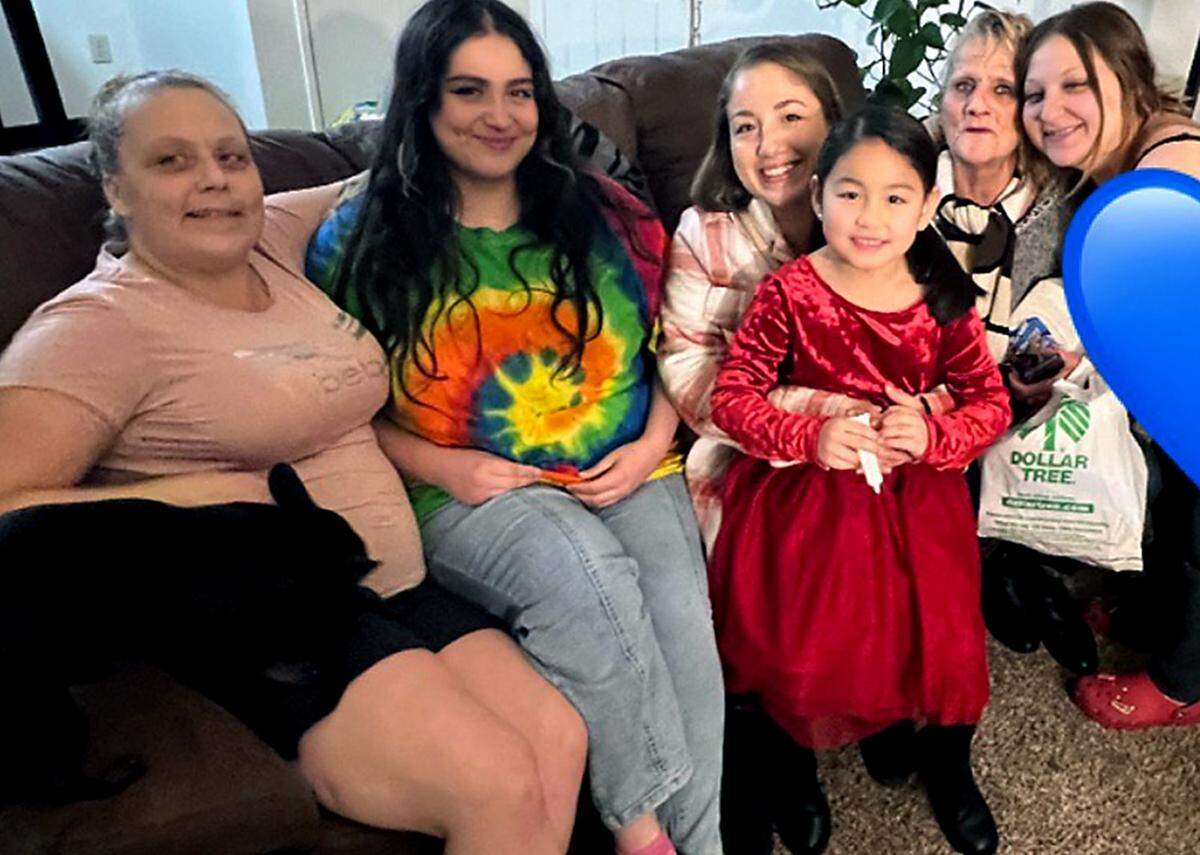 Sally Madrigal, second from right, pictured with her family. She was in a Seattle hospital after having a stroke when her home burned down.