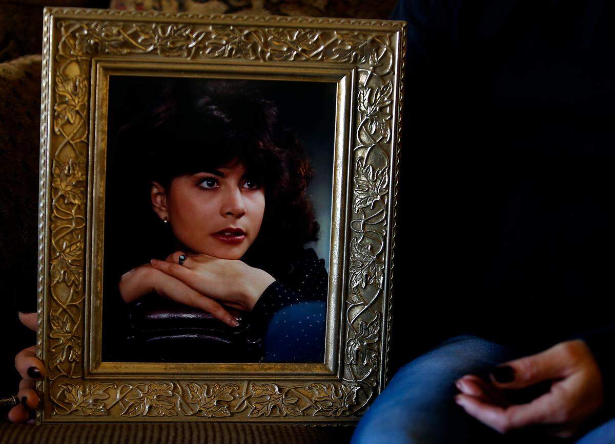 Kathy Shirey of Kennewick holds the framed 1980 Richland High School graduation portrait of her sister Linda Ramos-Moore whose body was recently discovered after she went missing in the Seattle area in November 1991.