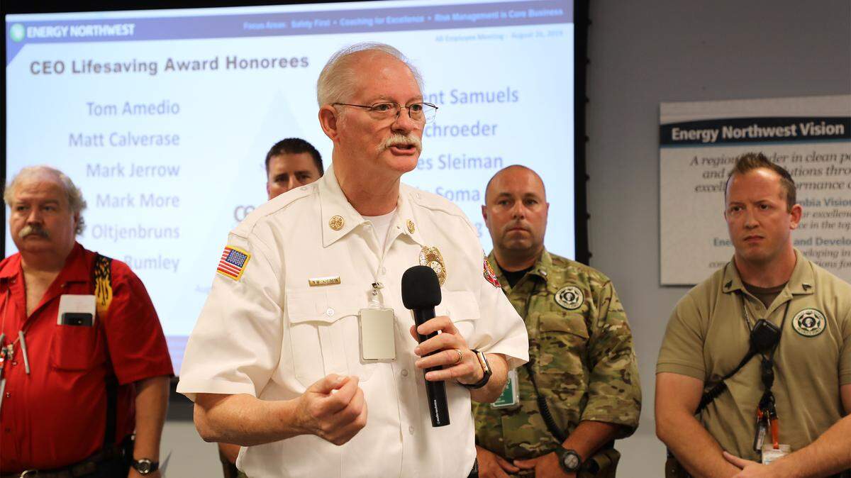 Hanford Fire Chief Norb Kuhman recognized a team of Energy Northwest employees in 2019 for their quick response that saved the life of a fellow employee.