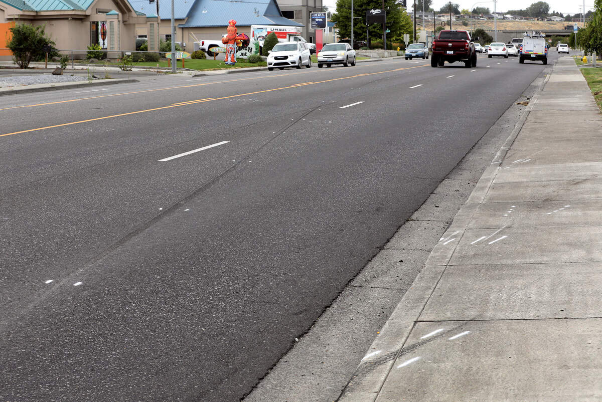 Police investigative paint marks the secene where motorcyclist Donald “Garth” Rettinghouse, 69, was struck and killed on West Columbia Drive at the North Jean Street instersection Sunday night in Kennewick. Valeria Benitez-Hernandez of Kennewick is being held in Benton County jail on $200,000 bail or bond on suspicion of vehicular homicide.