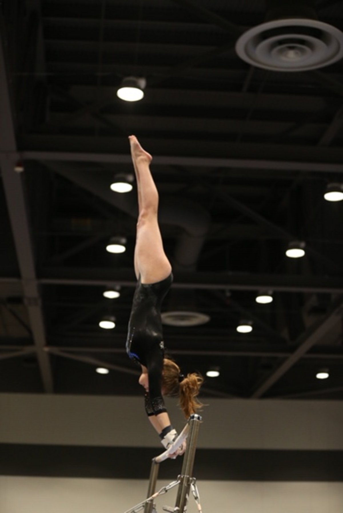 Emily Larson competes on the uneven bars.