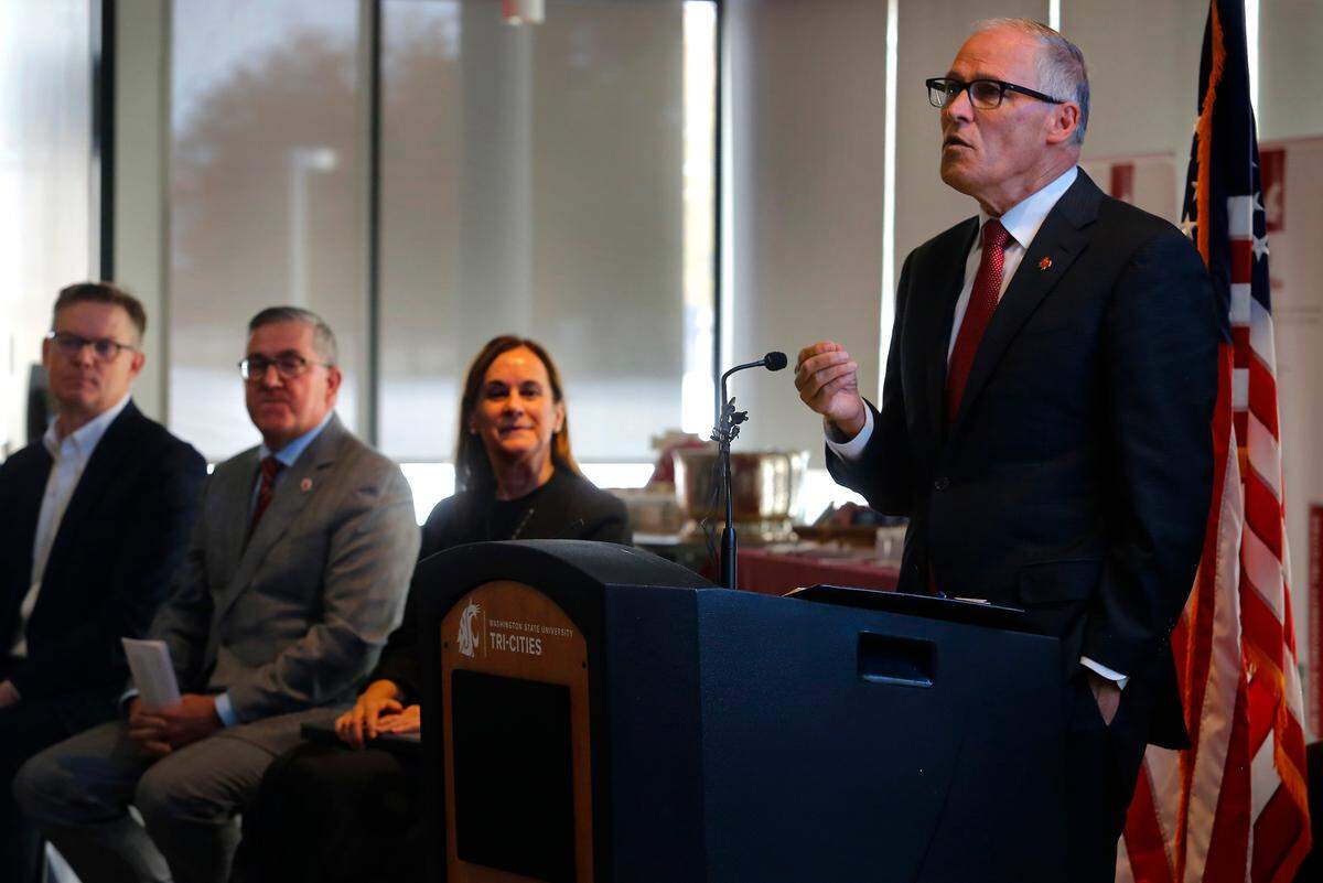 Gov. Jay Inslee announces the Institute for Northwest Energy Futures during a press conference Monday at the Washington State University Tri-Cities campus in Richland. Also taking part in the presentation, from left, were: TRIDEC president and CEO Karl Dye, WSU president Kirk Schulz and WSU Chancellor Sandra Haynes.
