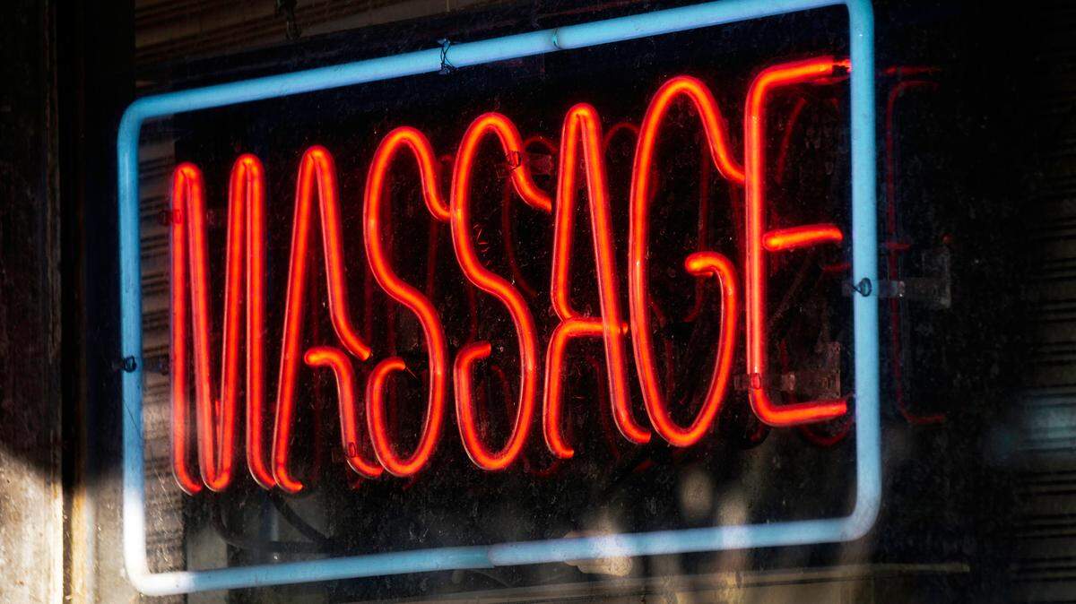 Red neon massage business sign.