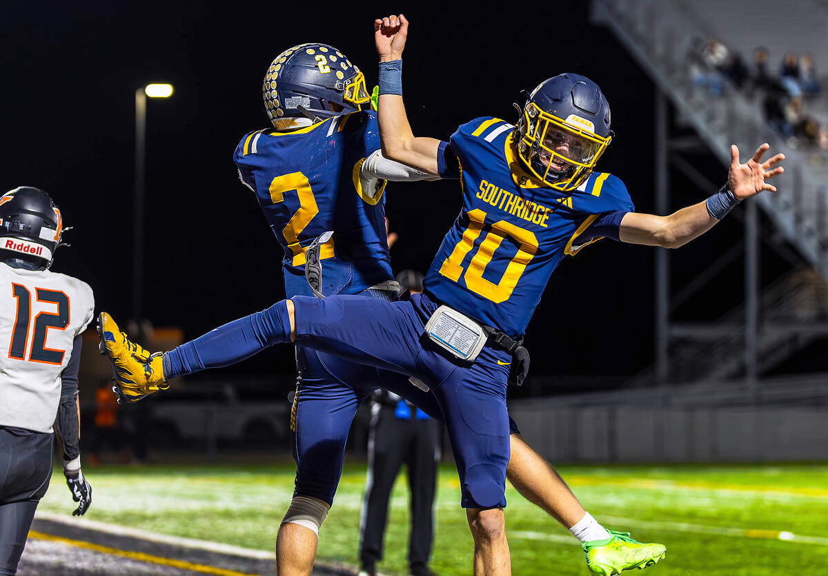 Southridge's Tayton Jackman (2) celebrates with quarterback Austin Hazenberg (10) following Jackman's 88-yard touchdown run against Kennewick in the fourth quarter Thursday at Neil F. Lampson Stadium in Kennewick.