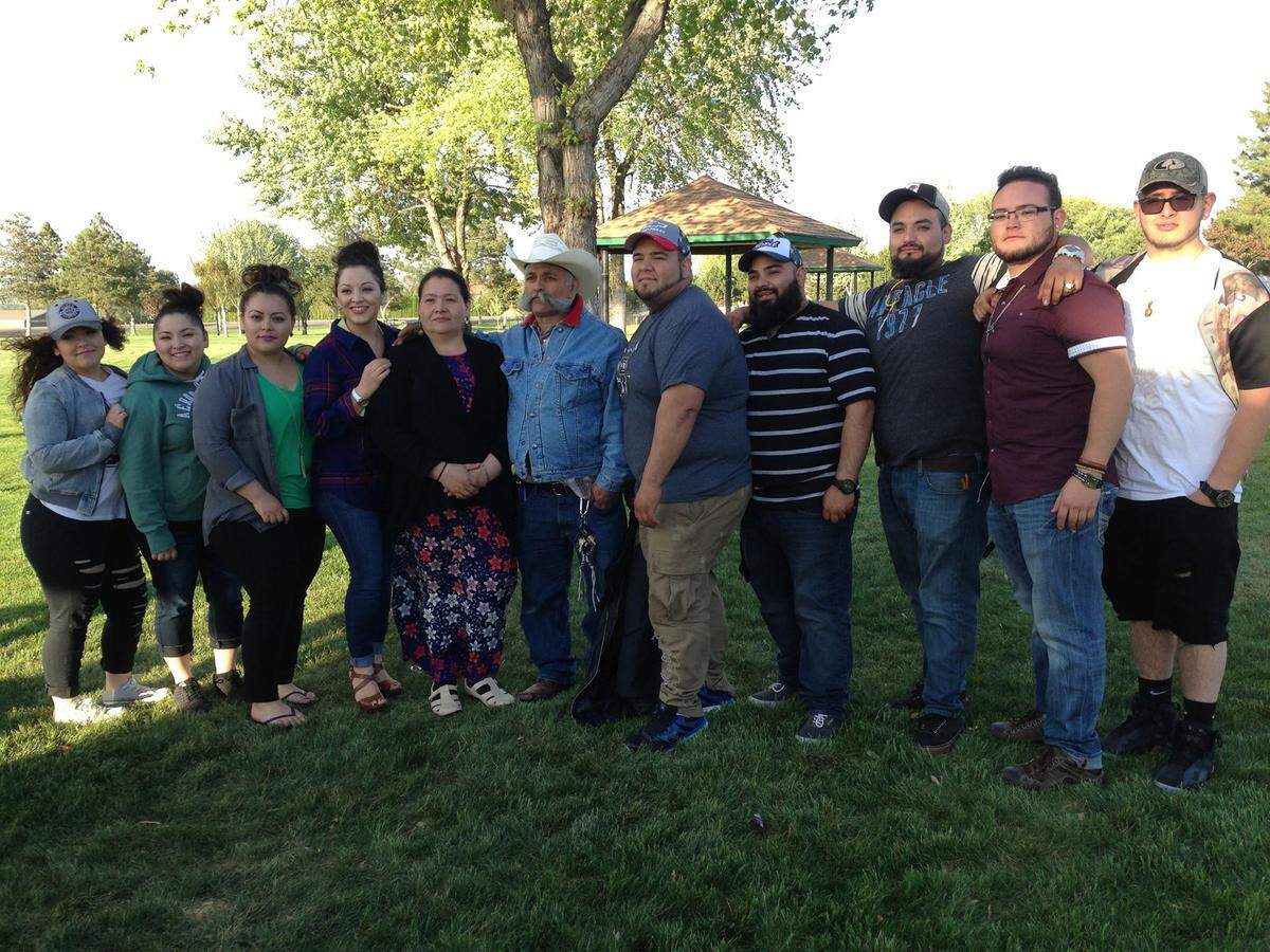 Estela Torres Rodriguez and Tiburcio Larios Rodriguez stand at the center of their nine children. Police believe Tiburcio and one of their sons, Clemente, were responsible for killing the woman and then disappearing.