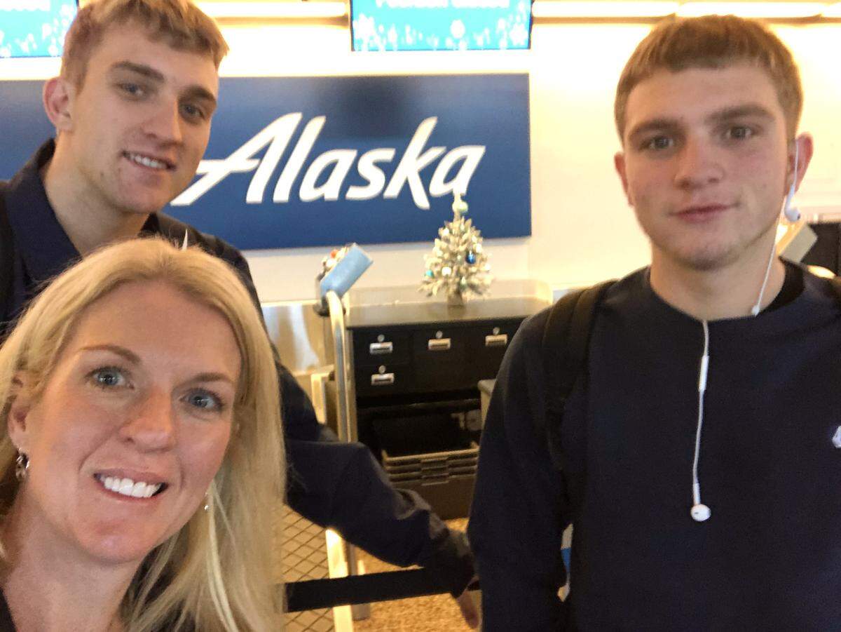 U.S. Army military spouse Carlie Lawes with sons Ayden and Dylan at Sea-Tac airport.