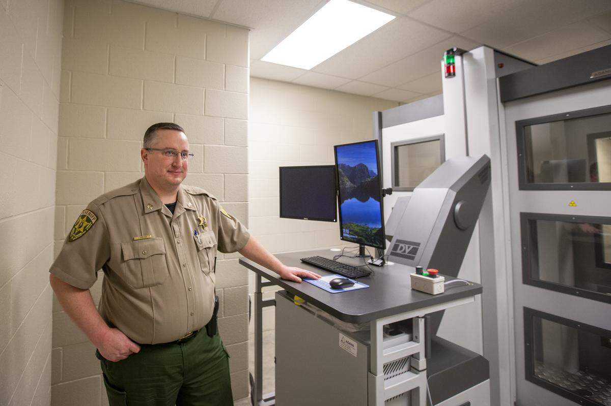 Benton County’s Sheriff’s Capt. Josh Shelton stands by the new X-ray scanner inside the Benton County jail. The new machine will check incoming inmates to make sure they are not smuggling in weapons or drugs.