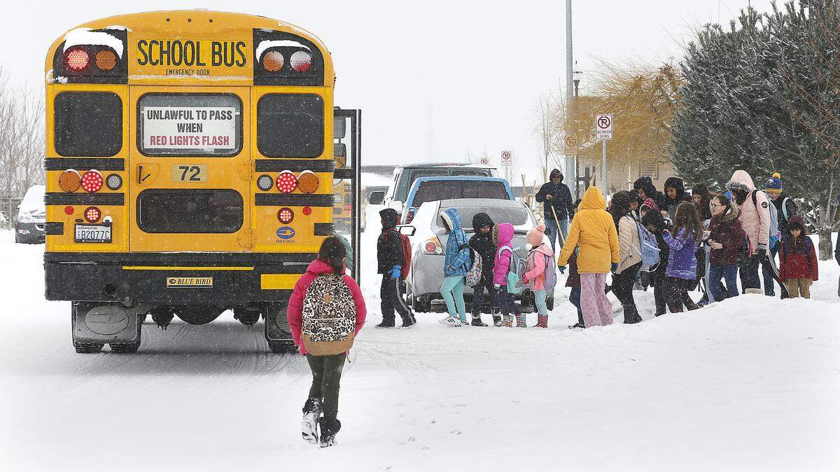 Pasco students in the Tierra Vida housing development in east Pasco line to get on their school bus last week after a two-hour delay..