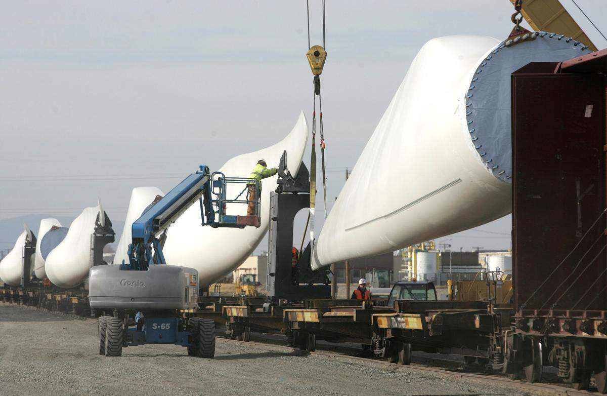A worker prepares to release a wind turbine blade from a rail car so it can be stored in the Big Pasco Industrial Center. The site was used in 2011 to receive turbine blades for the Lower Snake River Wind Project.