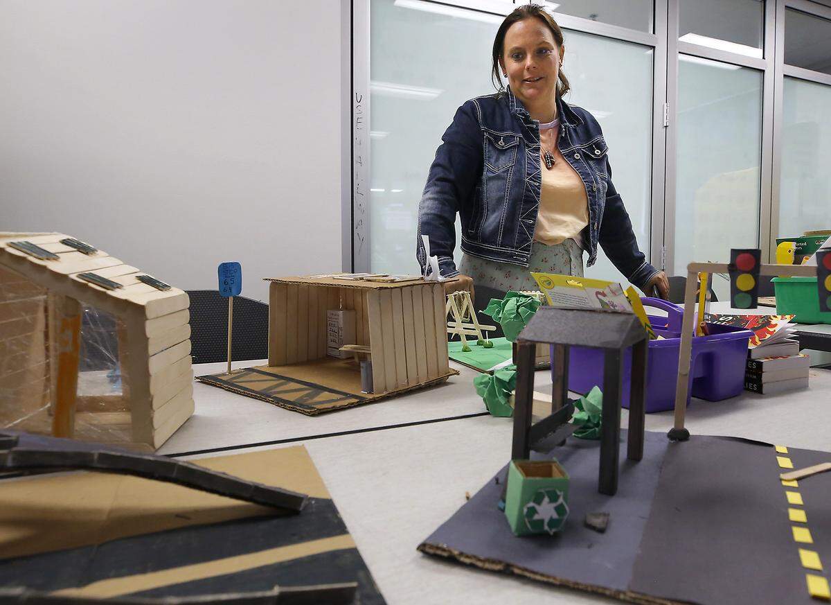 Orion High school teacher Rebecca Riley shows off some of the student-built displays that were part of their classroom projects that incorporated AI.