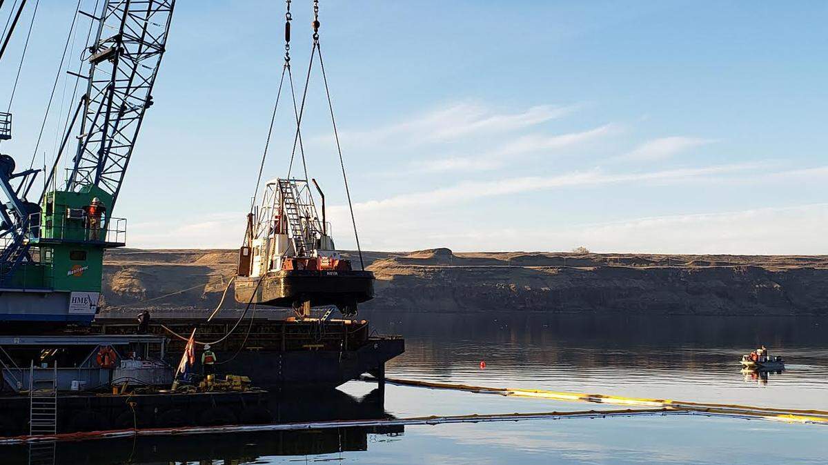 The Nova tugboat that sank in the Columbia River near Umatilla, Ore., upstream from McNary Dam in a windstorm Sunday night was lifted out of the river with a crane on Thursday. It was loaded onto a barge headed to a shipyard in Vancouver, Wash., for repairs. A light oily sheen on the river was being cleaned up but tanks holding 750 gallons of diesel remained intact, said officials. No crew was on board when the boat slipped from its moorings in winds up to 50 mph and was blown upriver until it sank.