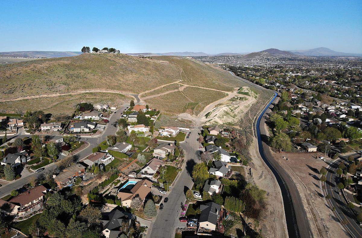 The Panoramic Heights Homeowners Association is opposing the proposed high density residential development of about 40 acres along the top of Thompson Hill in Kennewick. This drone view shows the proposed site and the Panoramic Heights residential development at lower left.