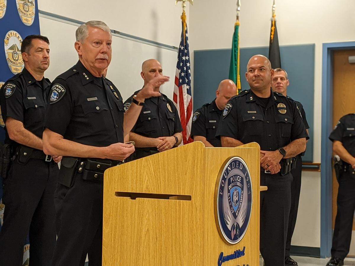 Police Chief Ken Hohenberg speaks at a 2021 promotion ceremony. Assistant Chief Chris Guerrero watches.