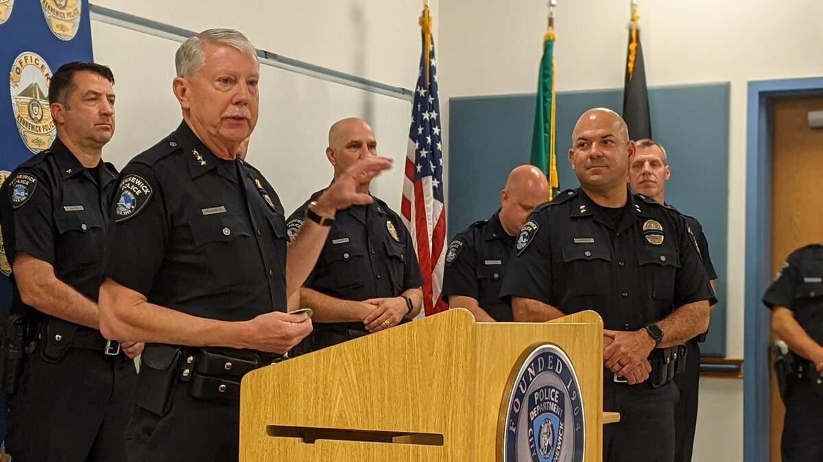 Police Chief Ken Hohenberg speaks at a Thursday promotion ceremony. Assistant Chief Chris Guerrero watches.