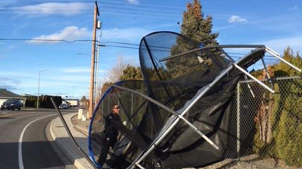 West Richland police pulled a trampoline from the side of the road after 20 mph winds blew it away.