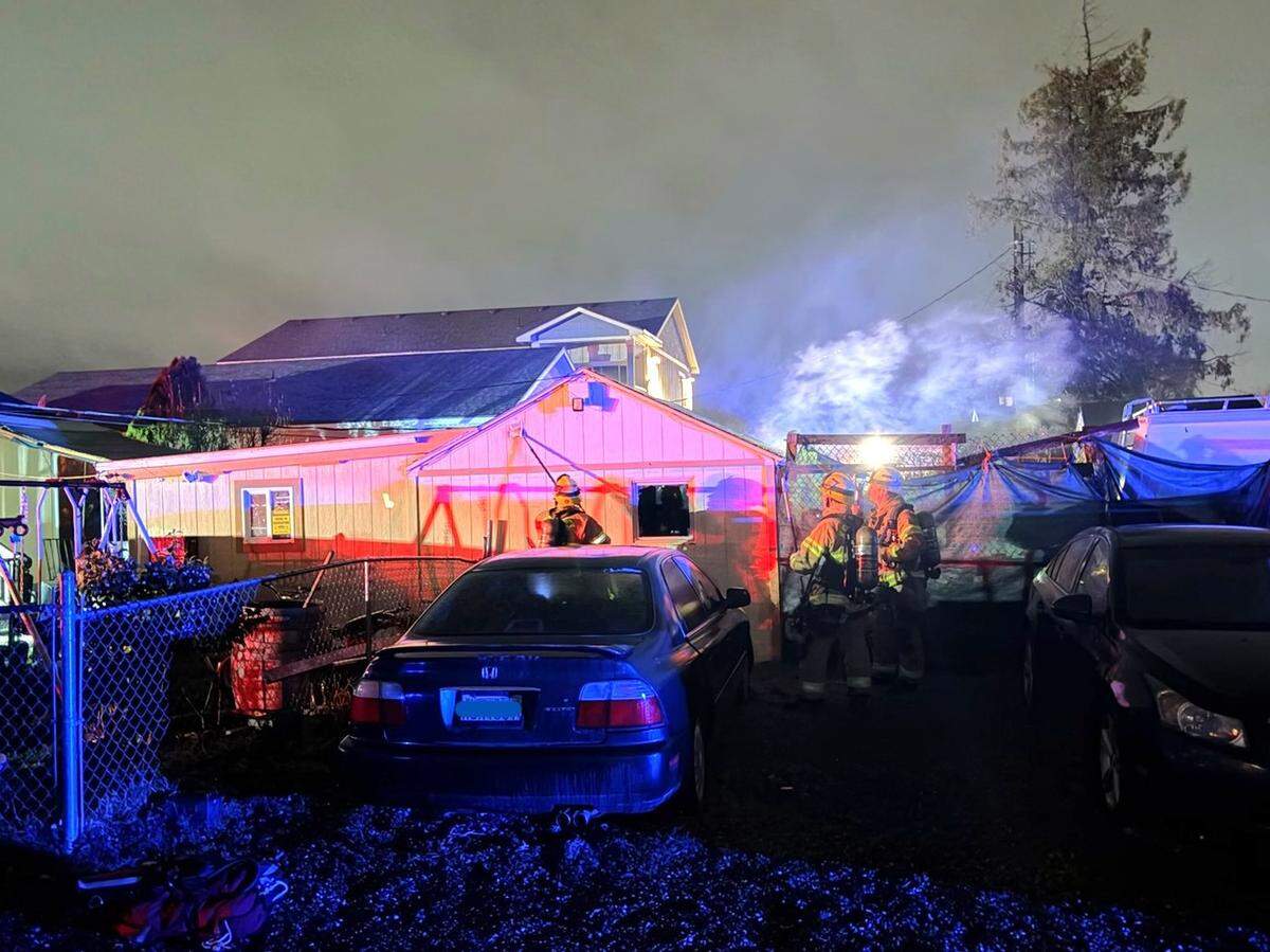 A Kennewick woman escaped a house fire unharmed thanks to her dog.