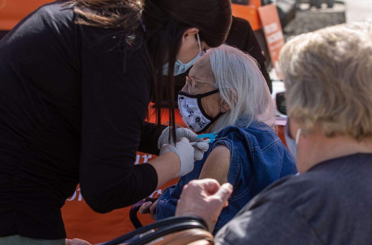 Betty Shwartz, 93, of Kennewick, gets a booster shot of the Pfizer vaccine during a free clinic at the Columbia Basin College campus in Pasco on Oct. 4. CBC partnered with the Washington State Department of Health’s Care-A-Van to offer all three available COVID-19 vaccines during the clinic.